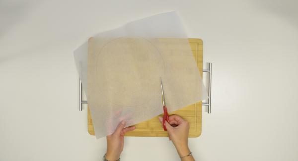 Con ayuda de una tapa de 24 cm, recortar un círculo de papel para hornear.