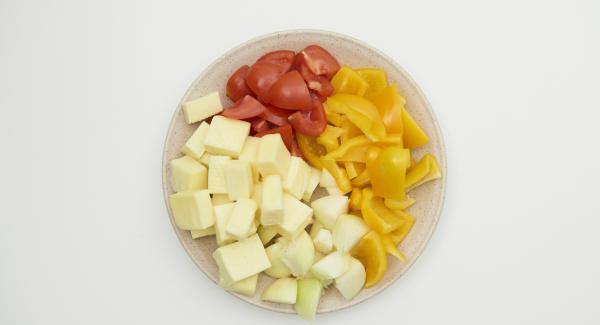 Pelar las cebollas, limpiar el tomate, el pimiento y cortar todo en trozos gruesos del tamaño de los dados de tofu.